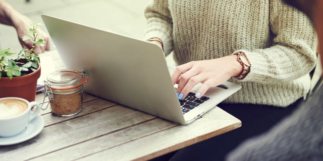 Woman typing on a laptop