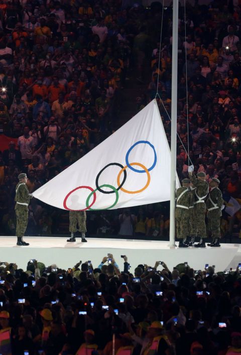 Opening ceremony: The Olympic flag is raised. 
