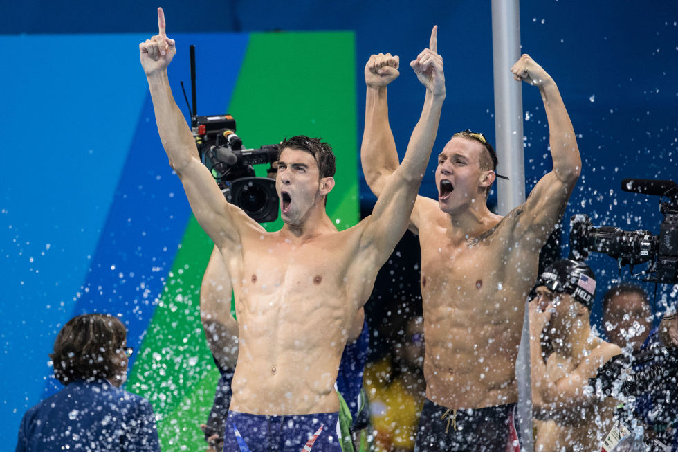 Day two: Michael Phelps celebrates after winning the Men's 4x100m Freestyle Relay, his 19th Olympic gold medal. 
