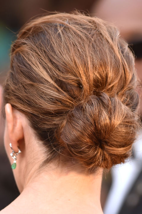 A ballerina bun gets a contemporary update by ensuring hair has texture when tied back.

